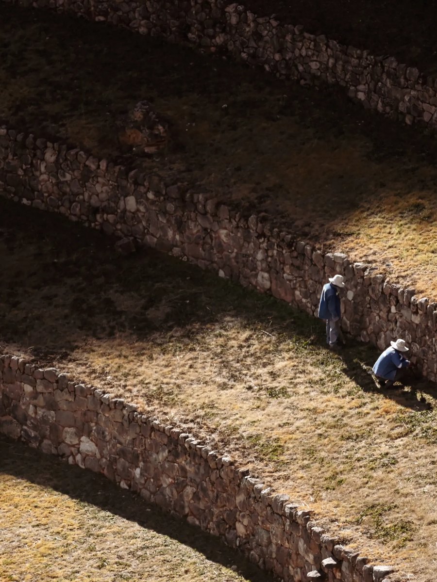Two farmers working the Inca terraces at Moray, Peru